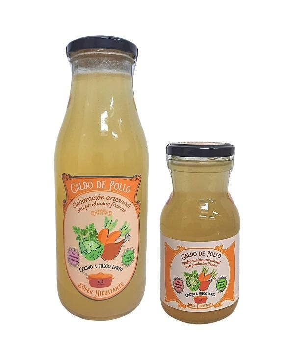 Two bottles of &#39;Caldo de Pollo&#39; on a white background