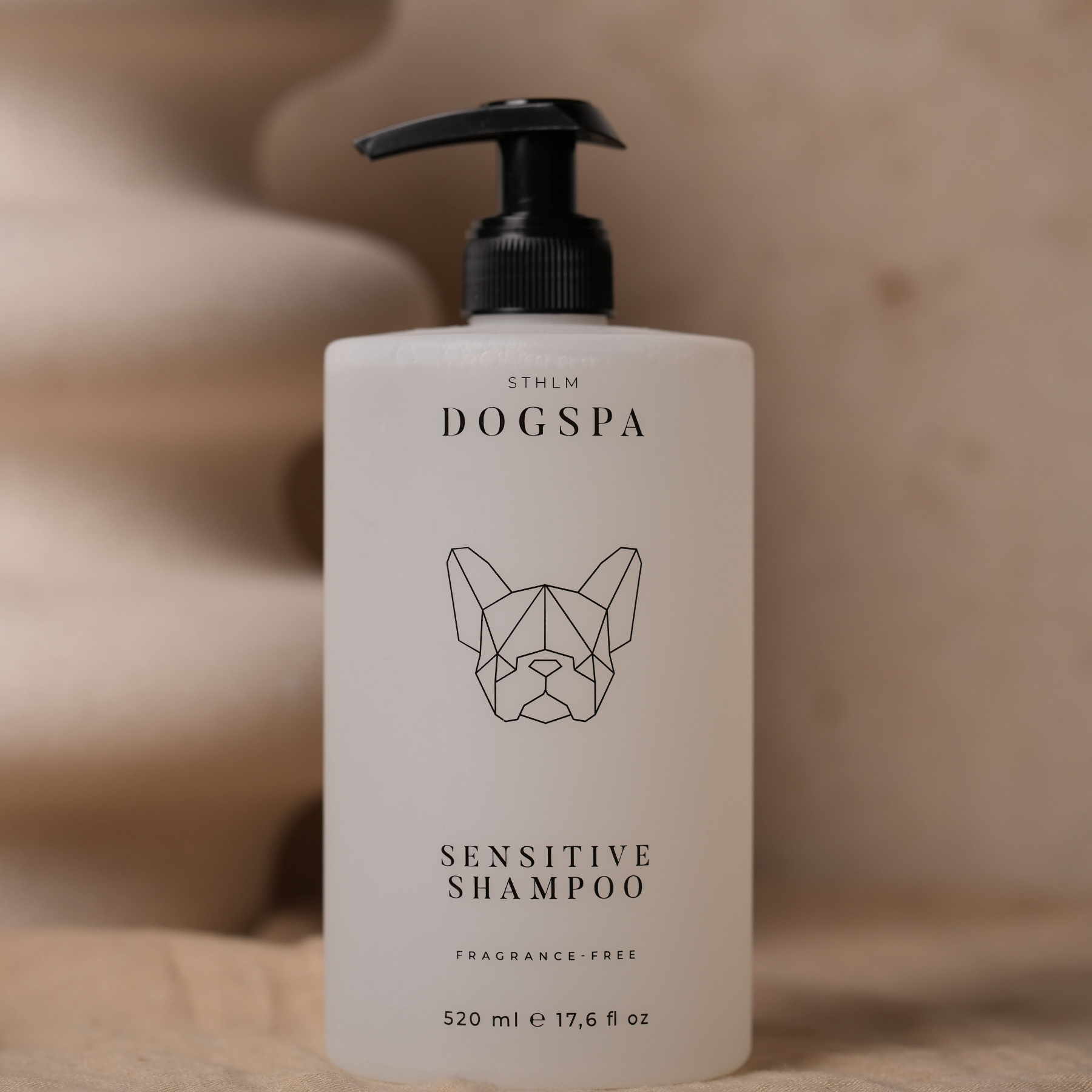 Dogspa sensitive shampoo bottle on a beige background