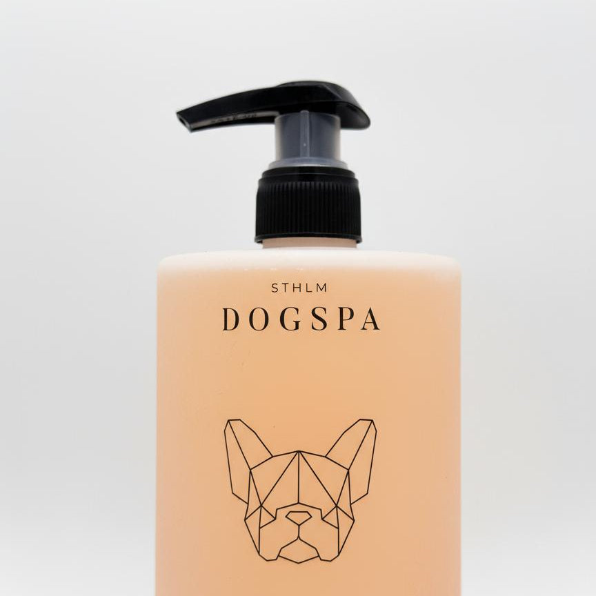 Dog shampoo bottle with pump labeled &#39;STHLM DOGSPA Hydrating Shampoo&#39; on a light gray background